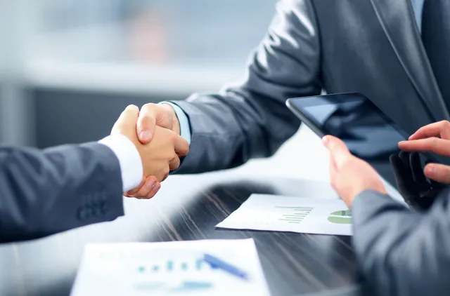 Handshake between two people in a business meeting