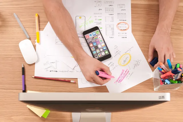 Interface sketches and handwritten notes on a desk